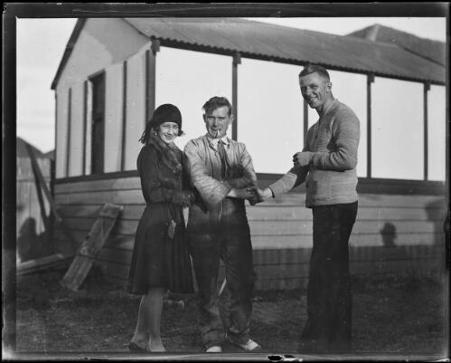 Parachute jumper Harry Thomas shaking hands with a man and a woman, New South Wales, 15 May 1930 [picture]