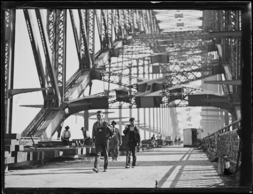 Workers walking across the Sydney Harbour Bridge during construction, New South Wales, ca. 1930 [picture]
