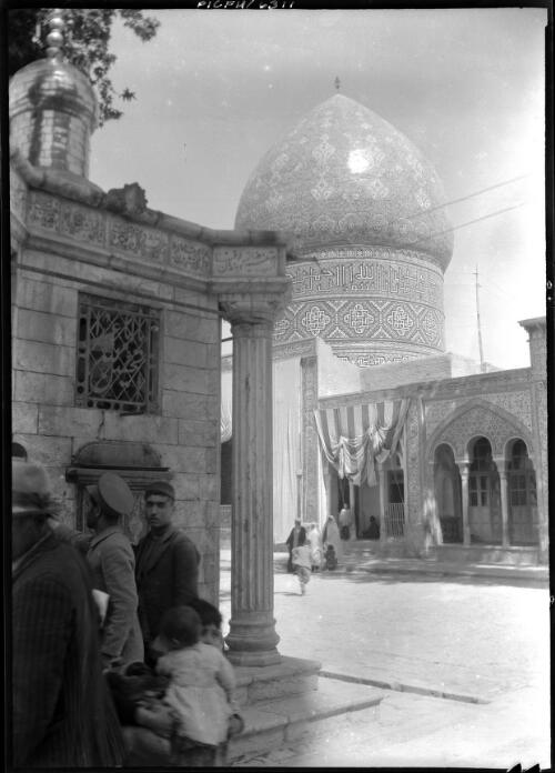 Visitors at a mosque with part of a smaller building showing in the foreground, Iran, ca. 1943 [picture] / [Frank Hurley]