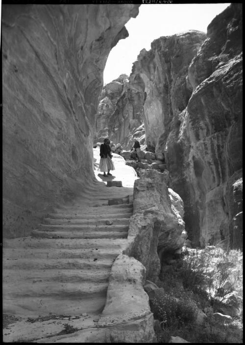[Figure descending stairs] [picture] : [Petra Valley, Jordan] / [Frank Hurley]