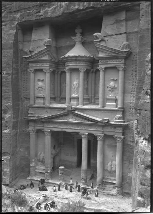 [El Khazne, Petra, men and camels in front of the monument] [picture] : [Petra Valley, Jordan] / [Frank Hurley]