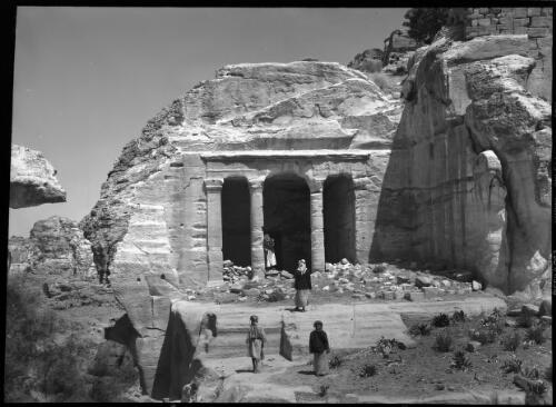 A tomb entrance Petra [exterior view of the Farasa triclinium (hall of religious feasts) Petra] [picture] : [Petra Valley, Jordan] / [Frank Hurley]