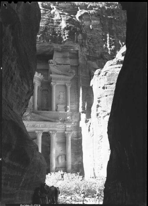 El Khazne Petra, first glimpse as the traveller emerges from the narrow ravine leading to the valley [picture] : [Petra Valley, Jordan] / [Frank Hurley]