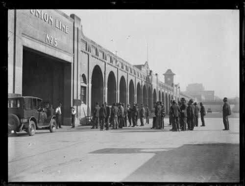 Gathering of men on a wharf outside the Union Line number 5 building, New South Wales, ca. 1930s [picture]