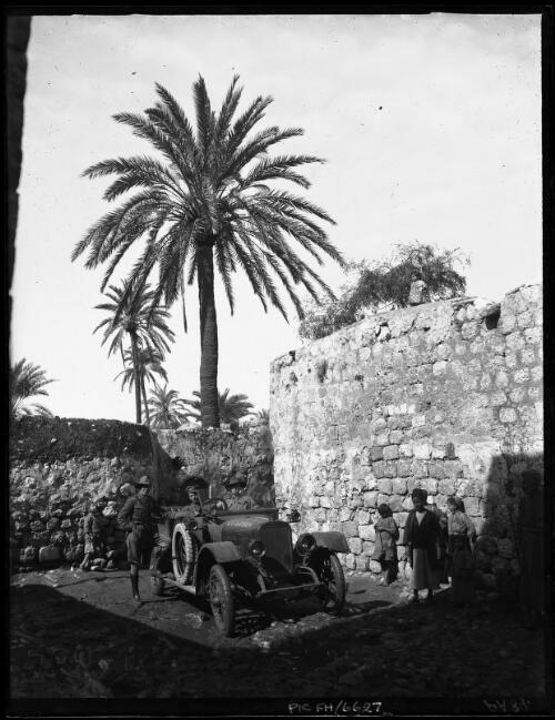 [Three men in military uniform with vehicle, Middle East, ca. World War I] [picture] / [Frank Hurley]