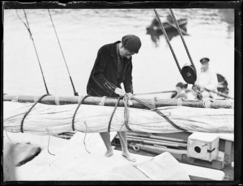 Sailor preparing the sails of the yacht Gullmarn for departure, New South Wales, 29 April 1932 [picture]