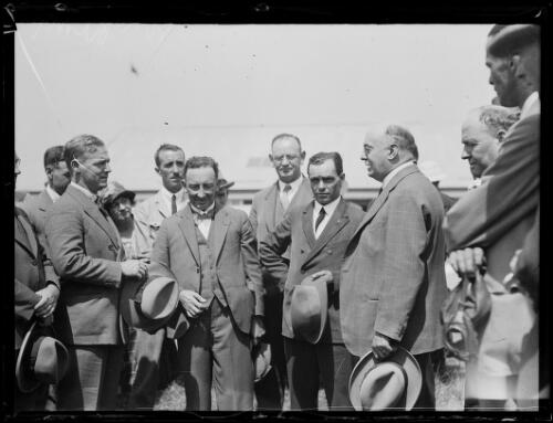 Aviator Herbert Hinkler standing with a group of men, New South Wales, ca. 1930s [picture]
