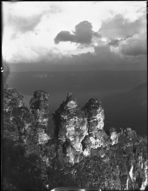 Three Sisters storm brewing, vertical [picture] : [Blue Mountains, New South Wales] / [Frank Hurley]