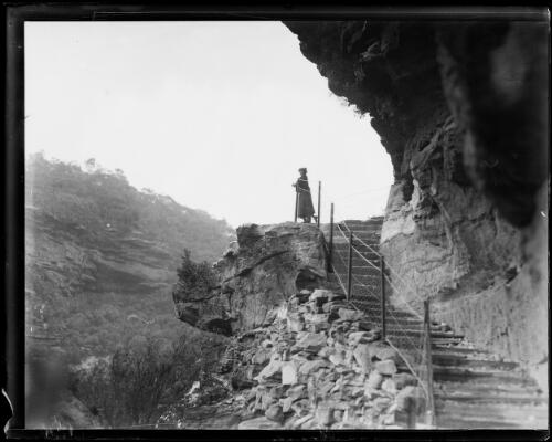 Woman standing on the scenic walk at the Jenolan Caves, New South Wales, 1 December 1933 [picture]