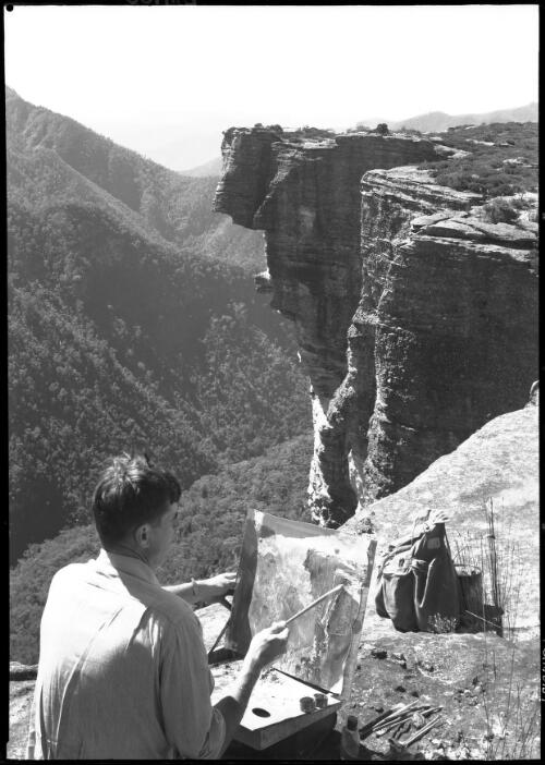 Kanangra Walls, artist painting [picture] : [Blue Mountains, New South Wales] / [Frank Hurley]