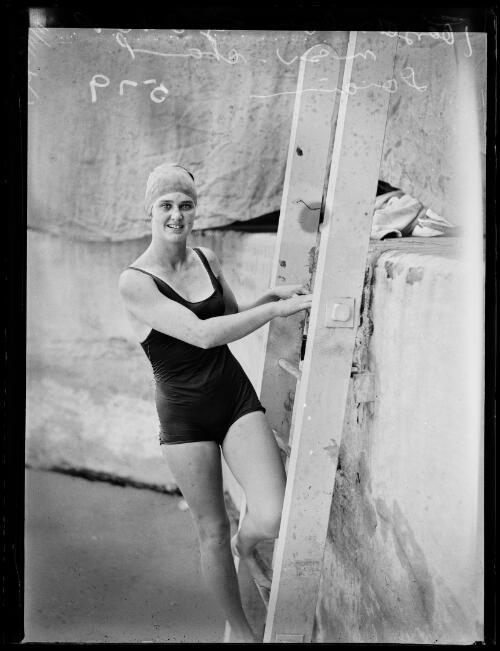 English swimmer Joyce Cooper on the ladder during the New South Wales Championships at the Domain Baths, New South Wales, 8 January 1934 [picture]