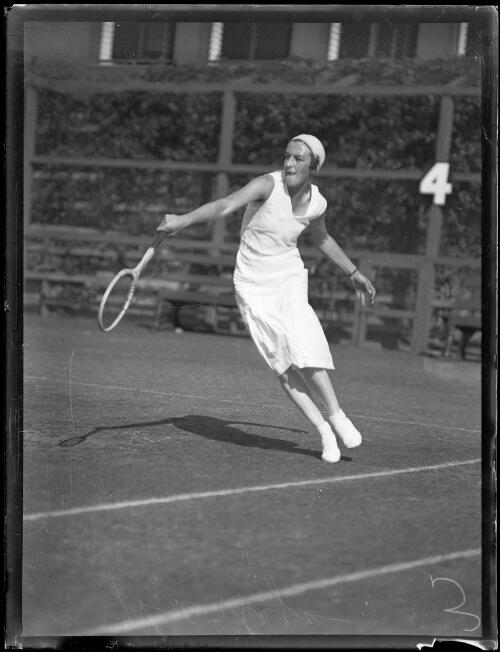 Miss Harlyn swinging a racket during a game of tennis, New South Wales, ca. 1930s [picture]