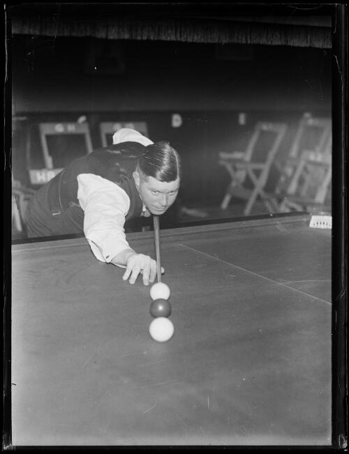 Billiard player Walter Lindrum lining up a shot, New South Wales, ca. 1930s [picture]