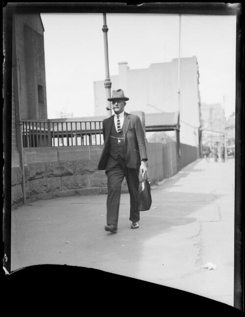 Constable E. Coombes walking along a street, New South Wales, ca.1933 [picture]