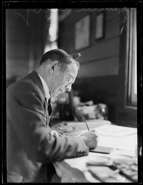 Ornithologist Neville William Cayley writing at his desk, New South Wales, ca. 1936 [picture]