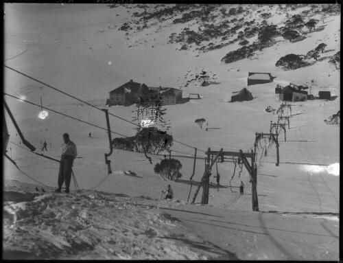 Looking over ski lift to Chalet [Charlotte Pass] [picture] : [Kosciuszko, New South Wales] / [Frank Hurley]