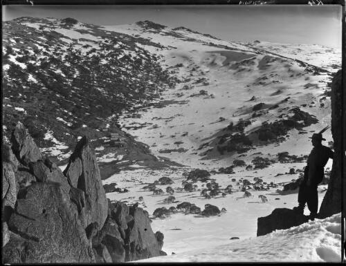 [Charlotte Pass, rocks and man in foreground] [picture] : [Kosciuszko, New South Wales] / [Frank Hurley]