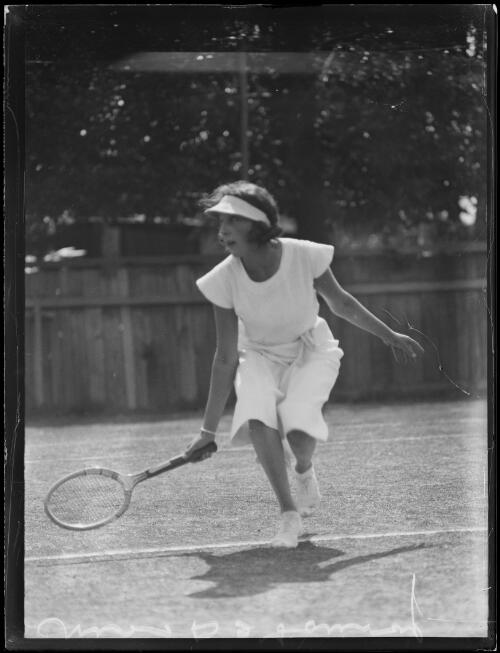 Tennis player Miss Marie De Launay taking a shot on the tennis court wearing a visor, New South Wales, 20 October 1933 [picture]
