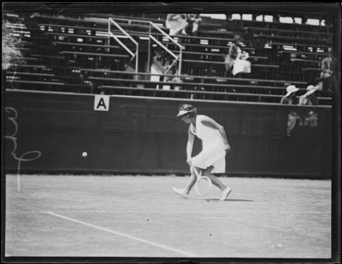 Mrs H.S. Utz after hitting a low backhand shot on the tennis court, New South Wales, 25 January 1934 [picture]