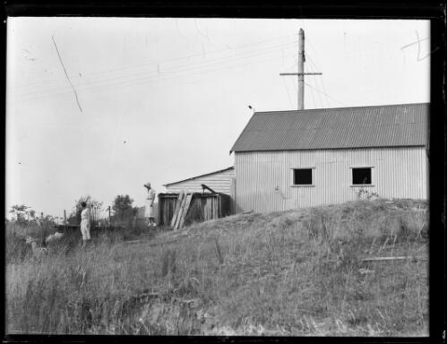 Two women standing beside a tin shed near a gold mine at Tumbarumba, New South Wales, 22 February 1933 [picture]