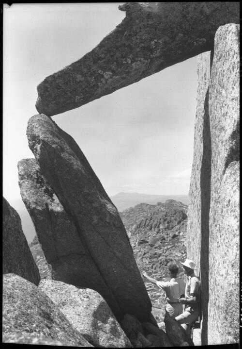 Summit of Mt Townshend two figures looking through portal [picture] : [Kosciuszko, New South Wales] / [Frank Hurley]