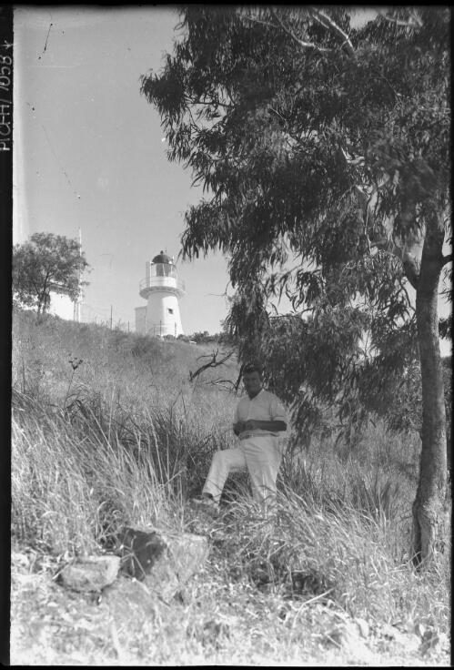 [Man on hill below lighthouse, Manly, 1] [picture] : [Sydney, New South Wales] / [Frank Hurley]