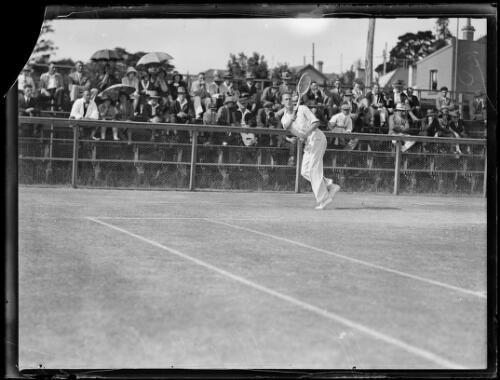 Tennis player W.B. Walker hitting a shot in front of a crowd, New South Wales, 9 September 1933 [picture]