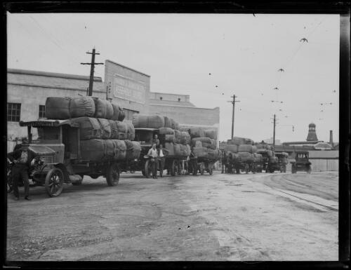 William McKeown trucks and drays being loaded at the Woolloomooloo Bay wharves, New South Wales, ca. 1920s [picture]