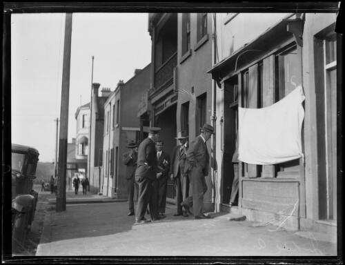 Judge Laurens Armstrong visiting underworld figure Kate Leigh's shop, Surry Hills, New South Wales, 25 April 1930, 1 [picture]