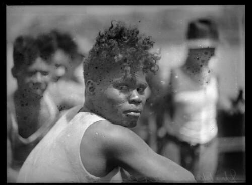 Indigenous sailor sitting with others, New South Wales, 1 February 1932 [picture]