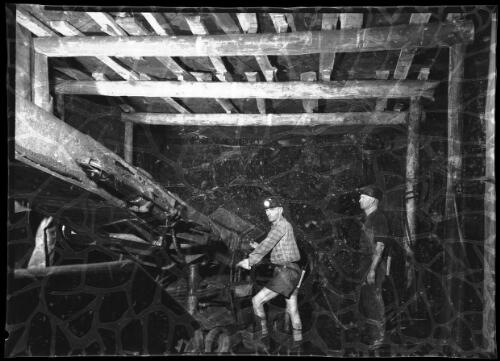 Miners operating machinery underground, Pelton Mine, New South Wales, 1 [picture] / Frank Hurley