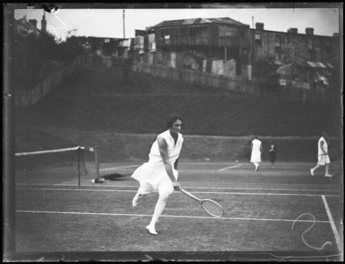 Vera de Bavay running for the ball during a tennis game at White City, New South Wales, ca. 1920s [picture]