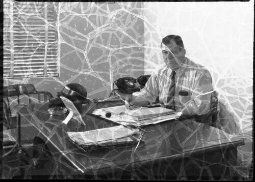 [Mine manager (?) at his desk, Pelton Mine, New South Wales] [picture] / [Frank Hurley]