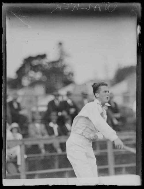 W.B. Walker serving during a tennis game in front of crowd, New South Wales, ca. 1930s [picture]