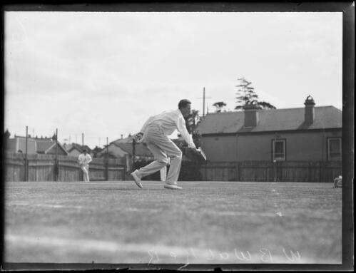 W.B. Walker hitting low backhand shot during a tennis game, New South Wales, ca. 1930 [picture]