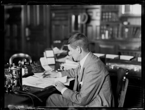 Mr Thomas Rainsford Bavin writing at a desk, New South Wales, ca. 1930s [picture]