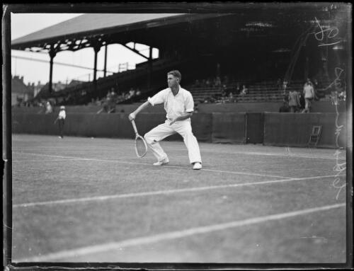 Tennis player R.O. Cummings squatting to hit a backhand shot at the State Championships, New South Wales, 29 April 1927 [picture]