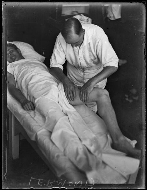 German athlete Leo Lermond receiving treatment on his leg by man at Petty's Hotel [?], New South Wales, 11 January 1930, 2 [picture]