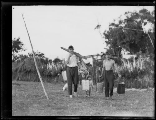 Two men carrying cans of water with a small child to their living quarters during the Great Depression, New South Wales, ca. 1932 [picture]