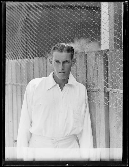 Tennis player Edgar F. Moon standing in front of fence, New South Wales, 7 February 1930 [picture]