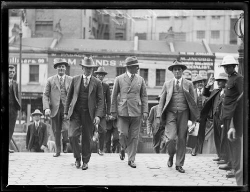 Colonel Eric Campbell founder of fascist movement the New Guard walking down a street with a group of men, New South Wales, 17 December 1931 [picture]