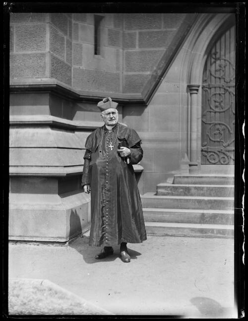Archbishop Michael Kelly standing outside St Mary's Cathedral, Sydney, ca. 1920 [picture]