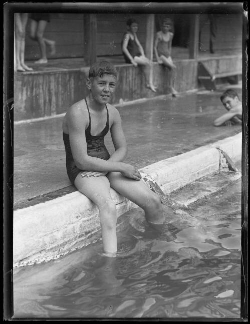 Swimmer D. Graye sitting on the edge of a pool, New South Wales, 5 November 1931 [picture]