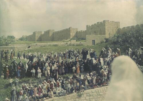 [Children and adults awaiting procession, with a Crusader castle in background] [transparency] / [Frank Hurley]
