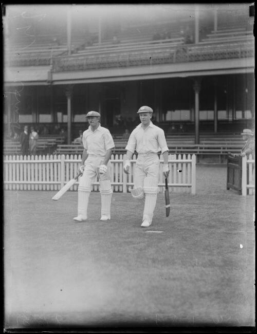 Cricketers T. Amos and S. Herd walking onto the field to play the New South Wales versus South Australia match, New South Wales, 1931 [picture]