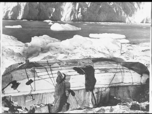 Our home on Elephant Island was built of two upturned boats laid side by side, twenty two of us lived like semi-frozen sardines within its cramped, dark interior [Shackleton expedition, 1916] [picture] : [Antarctica] / [Frank Hurley]