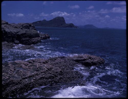 [Coral reef with islands in the background, North Queensland?] [transparency] / [Frank Hurley]
