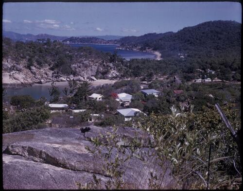 [Unidentified coastal town with a large rock in the foreground, Northern Territory] [transparency] / [Frank Hurley]