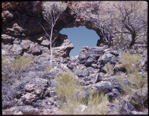 [Rock arch with rocks in the foreground, Northern Territory, 1] [transparency] / [Frank Hurley]