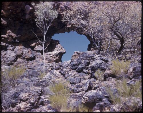 [Rock arch with rocks in the foreground, Northern Territory, 2] [transparency] / [Frank Hurley]